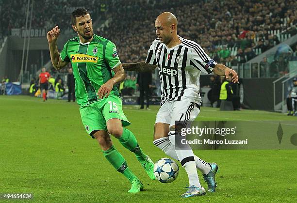 Simone Zaza of Juventus competes for the ball with Alvaro Dominguez of VfL Borussia Monchengladbach during the UEFA Champions League group stage...