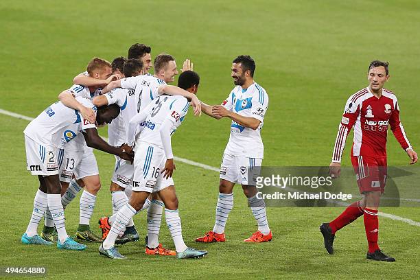 Victory players huddle around Jason Geria after he kicked a goal during the FFA Cup Semi Final match between Hume City and Melbourne Victory at AAMI...