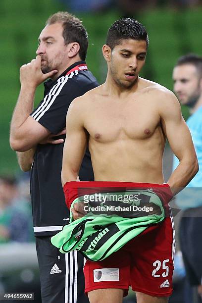 Souheil Azagane of the City prepares to take the field by putting on his top in front of City head coach Lou Acevski during the FFA Cup Semi Final...