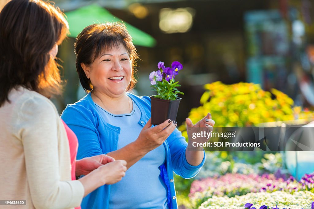 Senior woman shopping for potted plants and flowers