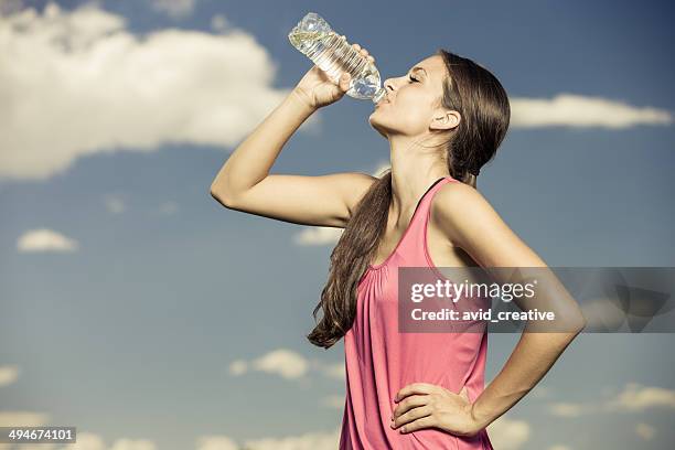 young woman drinking from water bottle - skinny girl stock pictures, royalty-free photos & images