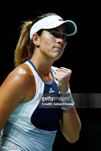 Garbine Muguruza of Spain reacts to a point against Angelique Kerber of Germany during the BNP Paribas WTA Finals at Singapore Sports Hub on October...