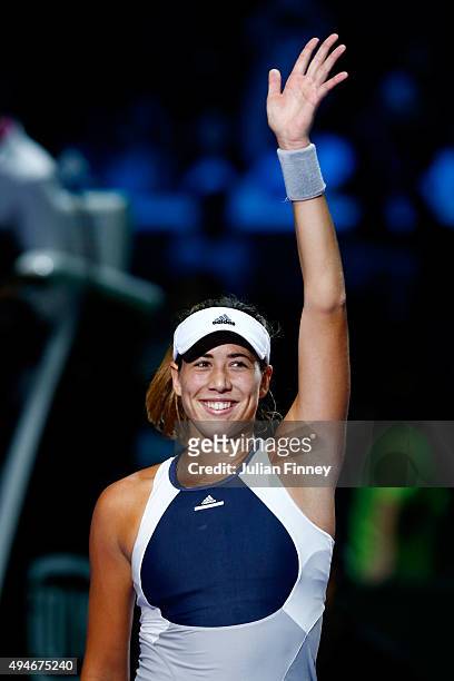 Garbine Muguruza of Spain waves to the crowd after defeating Angelique Kerber of Germany during the BNP Paribas WTA Finals at Singapore Sports Hub on...