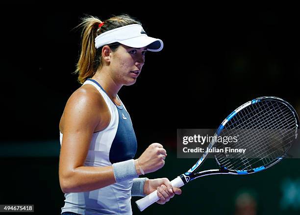 Garbine Muguruza of Spain reacts to a point against Angelique Kerber of Germany during the BNP Paribas WTA Finals at Singapore Sports Hub on October...