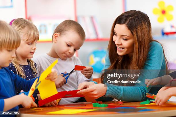 learning in preschool - 5 year old child using scissors stock pictures, royalty-free photos & images
