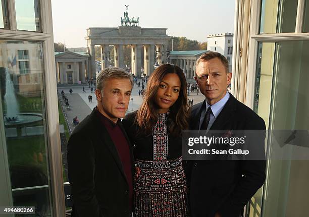 Christoph Waltz, Naomie Harris and Daniel Craig pose with the Brandenburg Gate behind during a photocall prior the German premiere of the new James...
