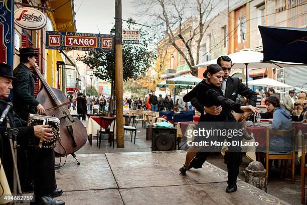 Argentinian professional tango dancers perform to entertain the guests of a restaurant at the Caminito in La Boca neighborhood on May 12, 2012 in...