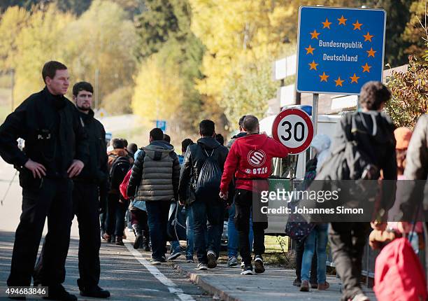 Migrants cross the German border to Austria on October 28, 2015 near Wegscheid, Germany. Bavarian Governor Horst Seehofer has accused the Austrian...