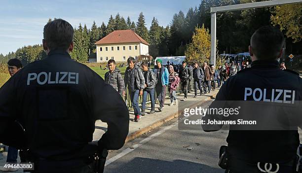 Migrants cross the German border to Austria on October 28, 2015 near Wegscheid, Germany. Bavarian Governor Horst Seehofer has accused the Austrian...
