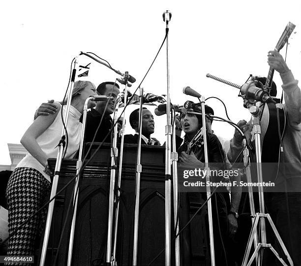 Singing before 25,000 civil rights marchers following speech by Dr. Martin Luther King, Jr. - Mary Travers, left; Harry Belafonte, 2nd on left; Leon...