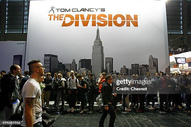 Visitors wait to play Tom Clancy's The Division, a video game published by Ubisoft at the Paris Game Week a trade fair for video games on October 28,...