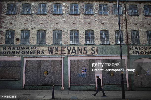 Man walks past a derelict building in Wolverhampton, which has been declared the most miserable place in Britain, on October 28, 2015 in...