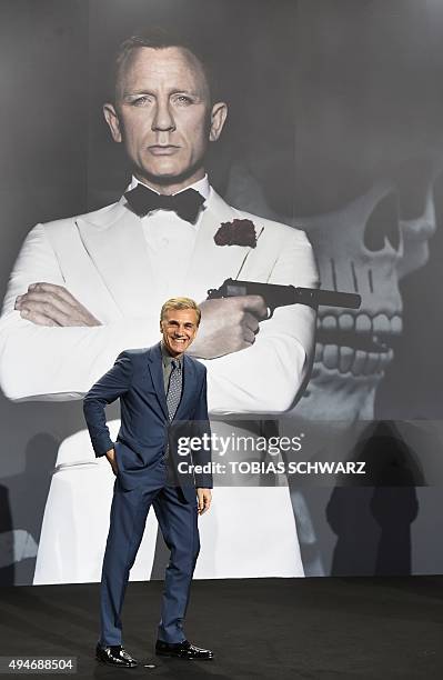 Austrian actor Christoph Waltz poses for photographers in front of a giant picture of British actor Daniel Craig at a photocall for the new James...