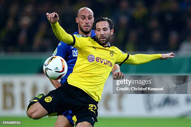 Gonzalo Castro of Dortmund scores the second goal against Daniel Brueckner of Paderborn during the DFB Cup match between Borussia Dortmund and SC...