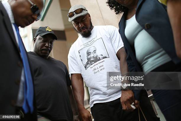 Willie Wilson and others pray together during a rally for Corey Jones in front of the State Attorney's office asking that the process of justice be...