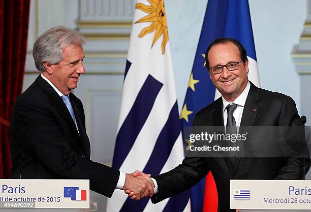 French President Francois Hollande shakes hand with Uruguayan President Tabare Vazquez during a press conference at the Elysee Palace Palace on...