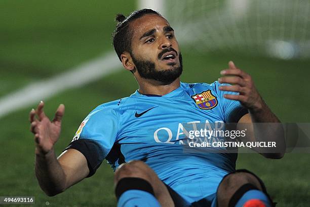 Barcelona's Brazilian defender Douglas sits on the field during the Spanish Copa del Rey Round of 32 first leg football match CF Villanovense vs FC...