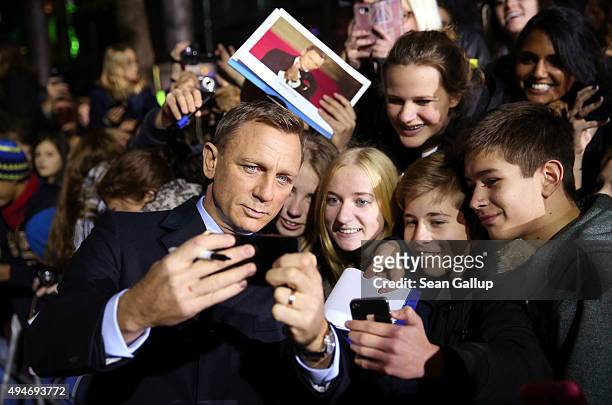 Actor Daniel Craig takes a selfie with fans as he attends the German premiere of the new James Bond movie 'Spectre' at CineStar on October 28, 2015...