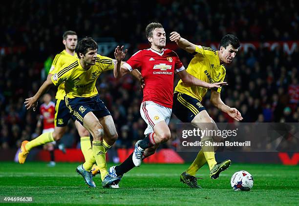 James Wilson of Manchester United takes on George Friend and Daniel Ayala of Middlesbrough during the Capital One Cup Fourth Round match between...