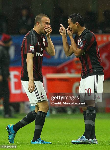 Luca Antonelli of AC Milan celebrates with his team-mate Carlos Bacca after scoring the opening goal during the Serie A match between AC Milan and AC...