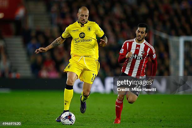 Alan Hutton of Aston Villa is chased by Juanmi of Southampton during the Capital One Cup Fourth Round match between Southampton v Aston Villa at St...