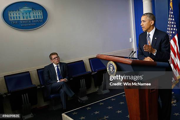 White House Press Secretary Jay Carney watches as U.S. President Barack Obama announces the resignation of Secretary of Veterans Affairs Eric...