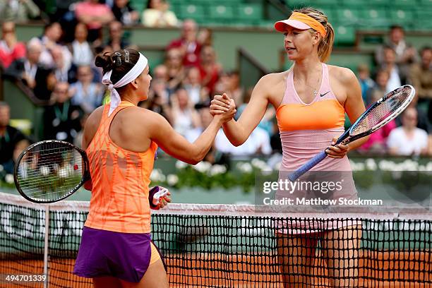 Maria Sharapova of Russia shakes hands at the net with Paula Ormaechea of Argentina after their women's singles match on day six of the French Open...