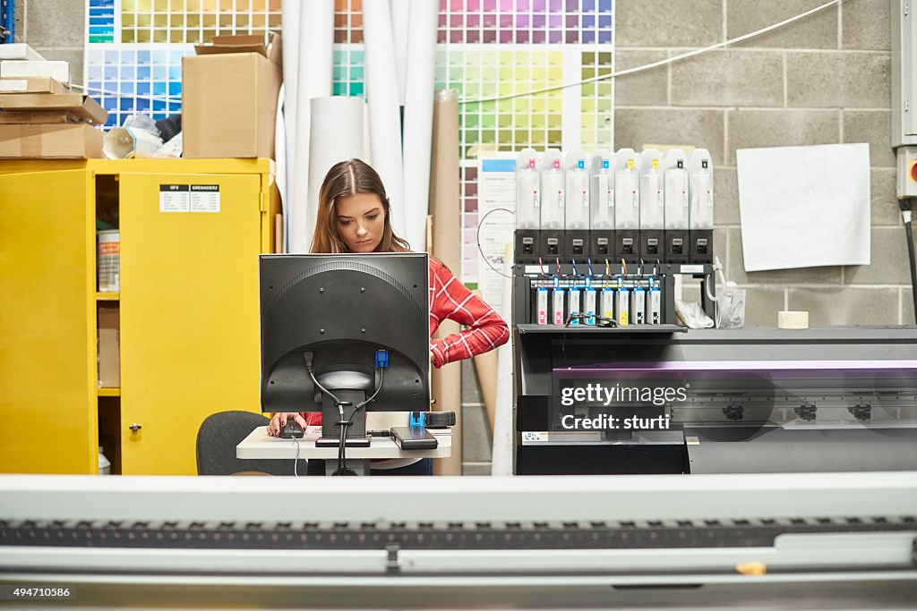 Young woman working at a digital printing company