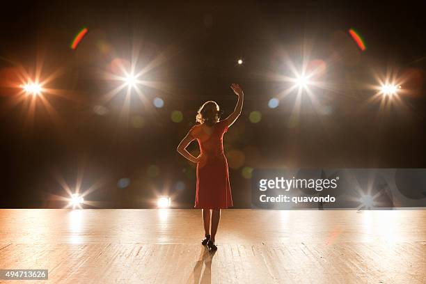live performer standing on stage with lights - actress stock pictures, royalty-free photos & images