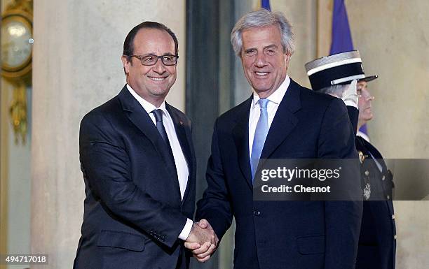 French President Francois Hollande welcomes Uruguayan President Tabare Vazquez prior to a official dinner at the Elysee Presidential Palace on...