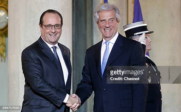 French President Francois Hollande welcomes Uruguayan President Tabare Vazquez prior to a official dinner at the Elysee Presidential Palace on...