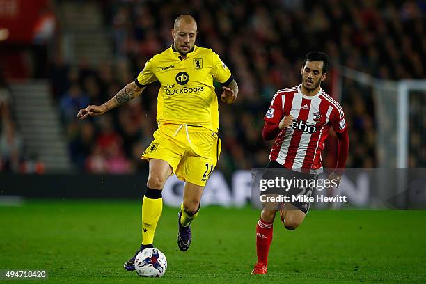 Alan Hutton of Aston Villa is chased by Juanmi of Southampton during the Capital One Cup Fourth Round match between Southampton v Aston Villa at St...