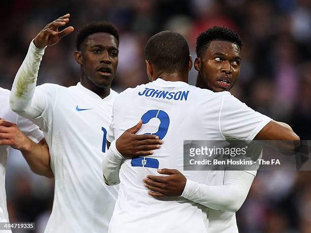 Daniel Sturridge of England celebrates with team mates Danny Welbeck and Glen Johnson as he scores their first goal during the International Friendly...