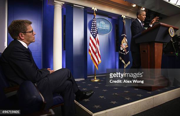 White House Press Secretary Jay Carney listens as U.S. President Barack Obama announces the resignation of Veterans Affairs Secretary Eric Shinseki...
