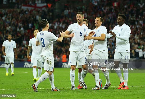 Phil Jagielka of England celebrates with team mates as he scores their third goal during the International Friendly match between England and Peru at...