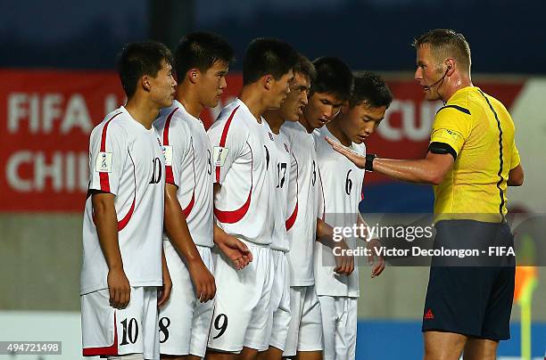 Choe Song Hyok, Yon Jun Hyok, Han Kwang Song, Jang Song Il, Kim Wi Song and Kim Ye Bom of Korea DPR listen as FIFA referee Danny Makkelie gives...