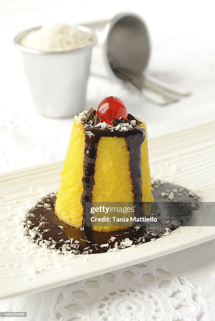 Coconut pudding with chocolate and rum sauce