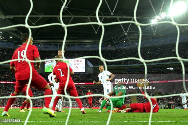 Phil Jagielka of England scores their third goal past Raul Fernandez of Peru during the international friendly match between England and Peru at...