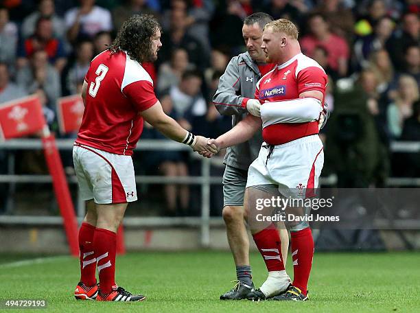 Injured Samson Lee of the Probables is consoled by teammate Adam Jones as he leaves the field during the Wales Senior Trial between Probables v...