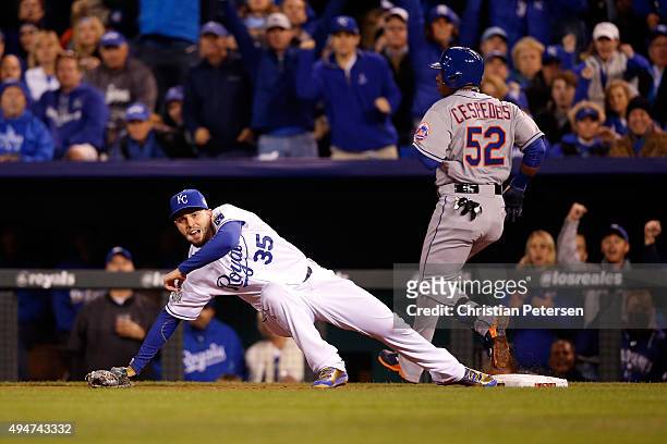 Yoenis Cespedes of the New York Mets is safe at first base as Eric Hosmer of the Kansas City Royals attempts to force him out in the fourth inning in...