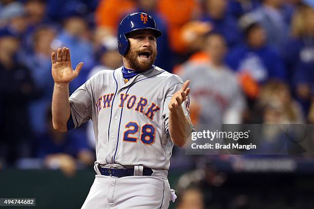 Daniel Murphy of the New York Mets celebrates after scoring in the fourth inning off a hit by Lucas Duda against the Kansas City Royals during Game 2...