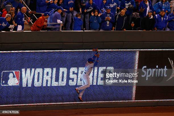 Yoenis Cespedes of the New York Mets catches a ball hit by Alex Rios of the Kansas City Royals at the wall in the sixth inning in Game Two of the...
