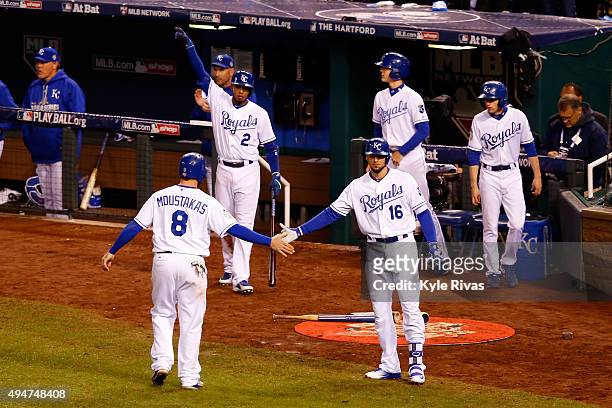 Mike Moustakas of the Kansas City Royals is greeted by Paulo Orlando of the Kansas City Royals after scoring a run on an RBI double hit by Alex...