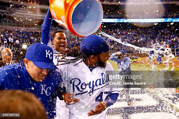 Salvador Perez of the Kansas City Royals douses Johnny Cueto of the Kansas City Royals after defeating the New York Mets 7-1 in Game Two of the 2015...