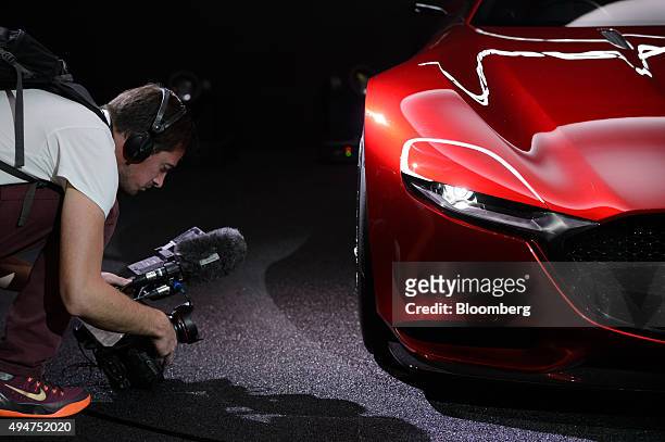 Cameraman films the hubcap of the Mazda Motor Corp. RX-Vision concept vehicle on display at the Tokyo Motor Show in Tokyo, Japan, on Wednesday, Oct....