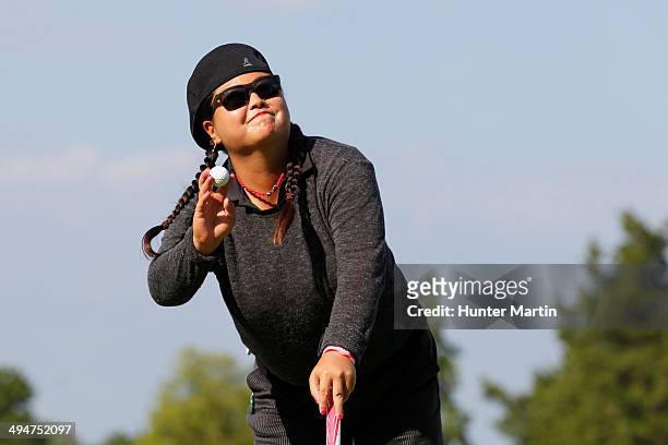 Christina Kim waves to the crowd after making birdie on the 18th hole during the first round of the ShopRite LPGA Classic presented by Acer on the...