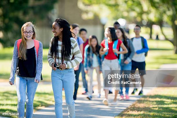 friends walking to class - high school student stock pictures, royalty-free photos & images