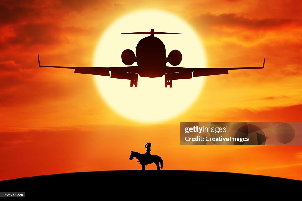 Woman riding horse on the hill under flying plane