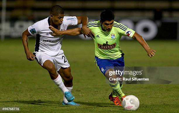 Irven Avila of Sporting Cristal struggles for the ball with Wilder Cartagena of San Martin during a match between San Martin and Sporting Cristal as...