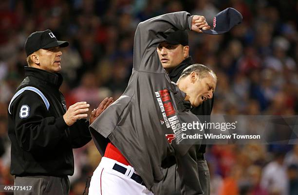 Filling in for ejected manager John Farrell of the Boston Red Sox, bench coach Torey Lovullo of the Boston Red Sox throws his cap while arguing with...